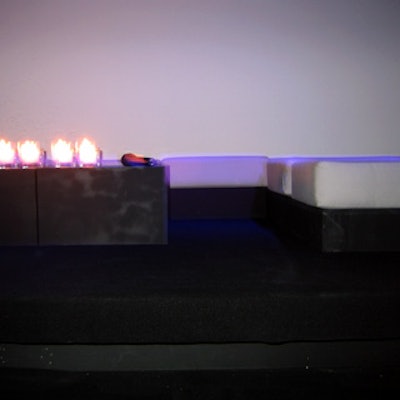 Loungey seating areas were created throughout the space by grouping low, black futons with gray cushions.