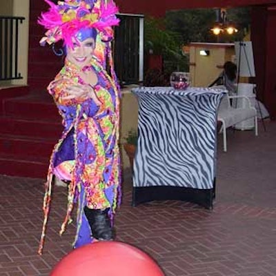 A ball-walking acrobat entertained guests at the dental office's opening event.