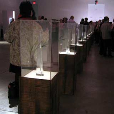A row of display cases with the magazine’s Baccarat awards lined the center of the space.