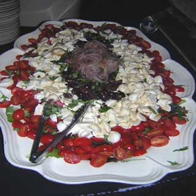 A delicious salad with olives, onions, and tomatoes awaited guests.