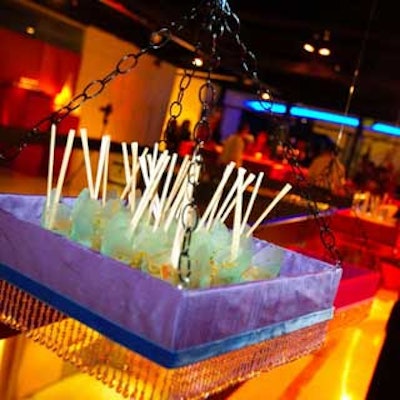 Good Gracious Events treated guests to Asian noodles from trays that hung from the ceiling, trimmed with Wildflower beaded linens.