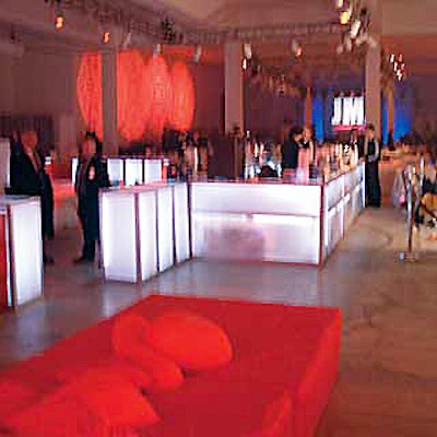 White underlit bars from RentQuest created a divider between the sit-down dinner area and the buffet reception area.