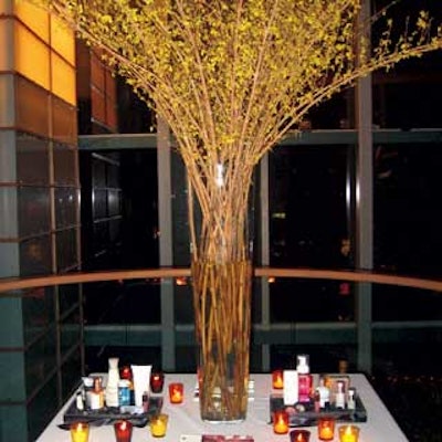 Tall branches of forsythia were arranged in clear vases by Lauren Messelian of Florishop to emphasize the monolithic space.