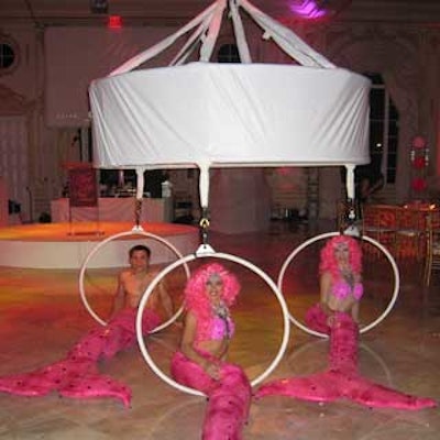 Mermaids, who greeted guests into the ballroom, were sitting on trapezes suspended from the ceiling.