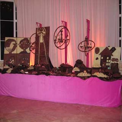 Godiva truffles were arranged on a dessert table that also featured artwork and chandeliers made out of chocolate by Larry Abel / De-signs.