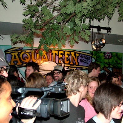 The downstairs party space was transformed into a campy outdoor scene with branches and dry ice.