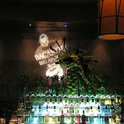 The bar featured premium spirits, a Bacardi gobo, and an arrangement filled with apples and overflowing with flowers.