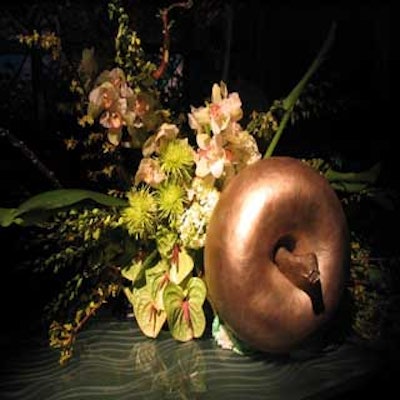 Centerpieces by conceptBAIT featured oversize bronze-colored apples with green-hued flowers.