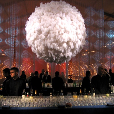 Upon entering the tent, guests encountered a large, fanciful orb covered with white ostrich feathers suspended over the bar.