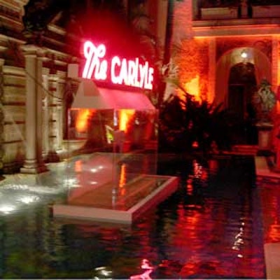 A neon Carlyle sign, which cast a red glow over the entire area, was set up over the mansion's pool.