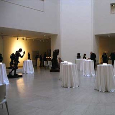 The cocktail hour was held in the fifth-floor Iris and Gerald B. Cantor Gallery. Tall highboy cocktail tables were covered with white linens and votive candles in square glass candleholders.