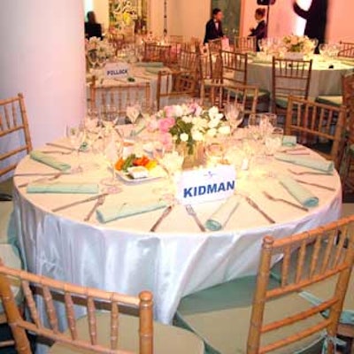 The understated dining tables featured green linens and natural-colored chair cushions from Party Rental Ltd.