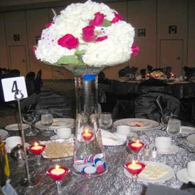 Pistils & Petals arranged white hydrangeas and red roses in clear vases with casino chips at the base.