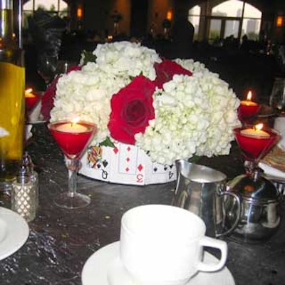 Another centerpiece had playing cards attached to its base and was surrounded by tiny red martini glasses with candles.