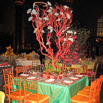 Calling to mind the evening’s fund-raising mission, Remco Van Vliet of Van Vliet & Trap pinned dollar bills flat on the top of his table’s green linens, and had little red toy men brandishing swords and climbing up an orange branch decorated with folded and fanned out dollars (metaphor, anyone?).