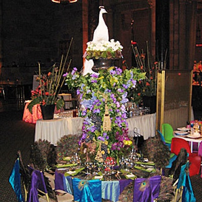LMD’s Lewis Miller topped his table with a white peacock—the bird was an apt symbol of the designers showing off at the benefit—perched above a leafy arrangement of cascading purple flowers mixed with elaborate tassels and fruits like strawberries, grapes, and cherries. Peacock feathers decorated the tabletop and the backs of the chairs as well.