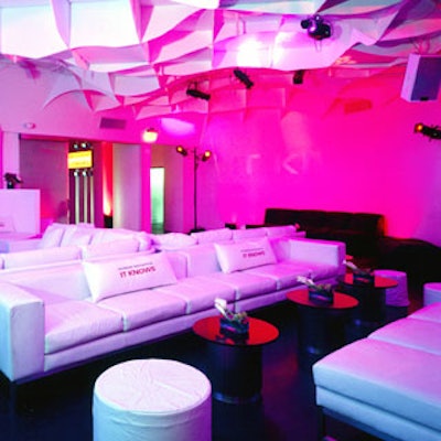 Guests reclined on sleek white lounge furniture adorned with Pioneer-branded pillows.
