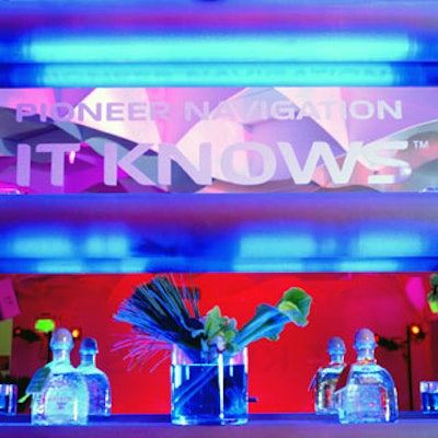 Flowers in blue-hued water by LA Premier and tequila from event sponsor Patron sat atop illuminated bars.