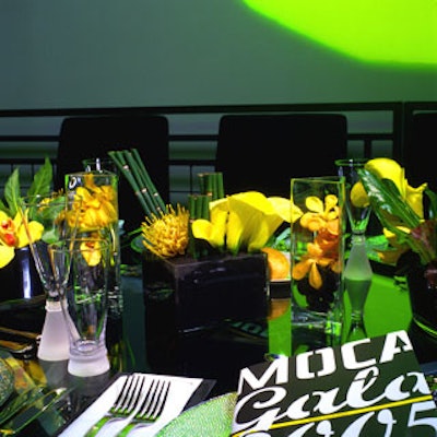 Custom made glass tables of varying sizes were arranged on five dining levels, with yellow orchids and calla lilies in different small glass vases as centerpieces.