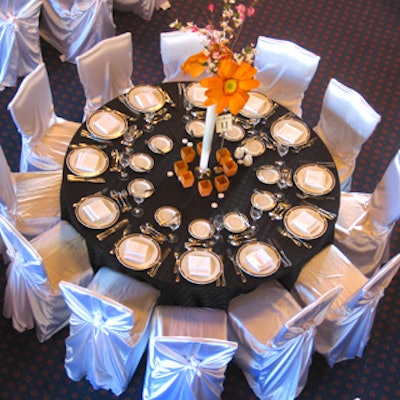 Silver chair covers allowed the colourful gerbera daisy centerpieces to pop.