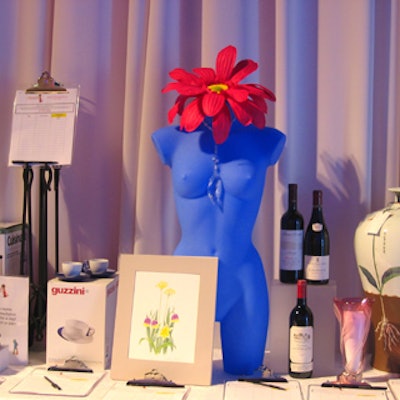 Decor in the silent auction area enhanced the disco-era look with electric blue mannequin torsos with gerbera headpieces.