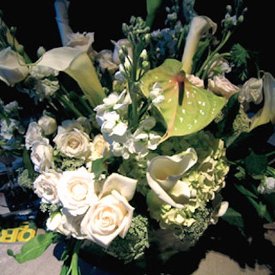 Cocktail tables were decorated with organic flower centerpieces.
