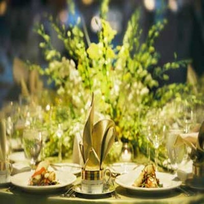 Low green-and-white orchid centerpieces accented the apple green tables.