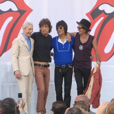 The Rolling Stones assembled on a stage below the balcony after their performance.