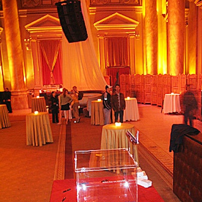 Fifty-foot panels of sheer white fabric hung from the venue's ceiling and draped down around two banquettes to frame the ballroom and give the space a more intimate feel.