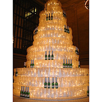 Geoff Howell created a giant wedding cake out of 4,000 champagne flutes at Brides magazine's Cakewalk at Grand Central promotional event in Vanderbilt Hall.