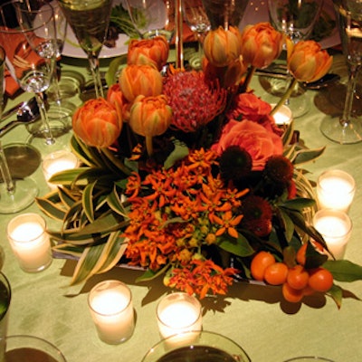 The color scheme was carried over into the low floral arrangements, with orange designs dominating the green tables and vice versa.