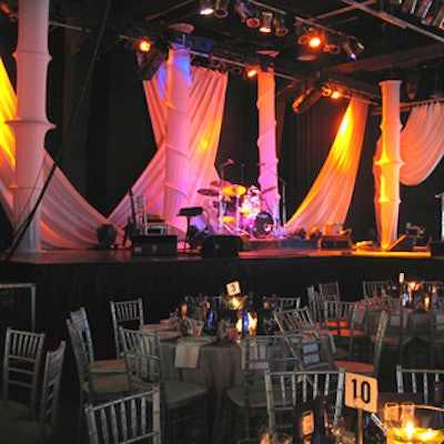 The stage design for Matt Dusk's performance included a white spandex structure with showy pink, orange, and gold lighting from the team at the Kool Haus.