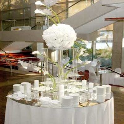 Nancy Berry's dramatic floral centerpieces included pale calla lilies and a plexiglass tower supporting white hydrangeas.