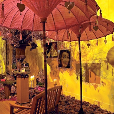 The hair vignette featured a small faux maple tree with orange and red foliage and teardrop-shaped glass votive-candle holders suspended from the branches.