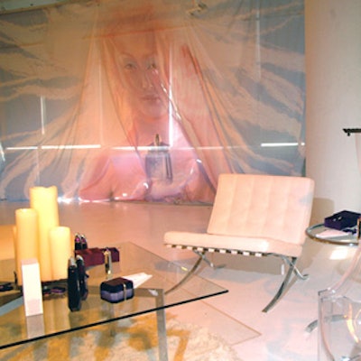 White drapes printed with the promotional shot of the fragrance—a alien-looking model holding the perfume bottle—from Imagekings hung over the windows of the studio.