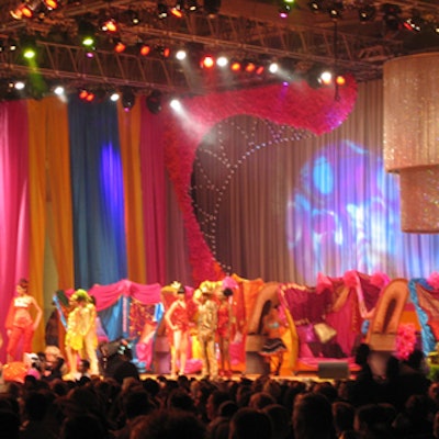 The fashion show included dancers and models in brightly coloured costumes.