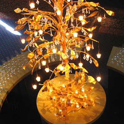 Pinney created a tree with faux gold leaves and tea lights suspended from its branches at the centre of the round bar.