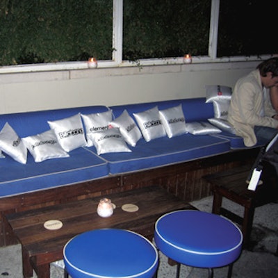 Dozens of branded pillows filled the banquette seating areas of the after-party.