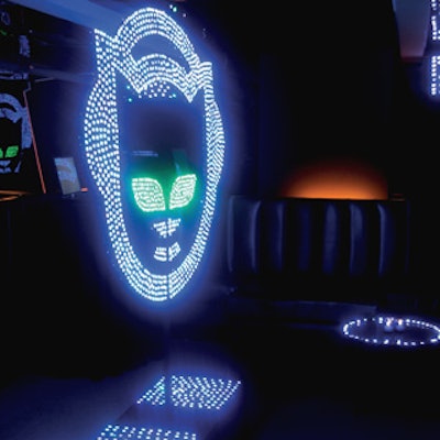 Guests could download music inside Napster's glowing lounge, outfitted with a large stand studded with small blue and green magnetic LED lights in the form of Napster's cat head logo. The room's mirrored walls maximized the glow.