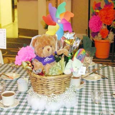 Centerpieces filled with toys sat on 'clouds' of baby's breath.