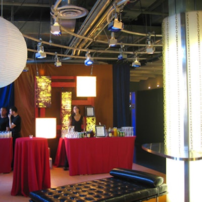 Creative lighting columns with chains cascading from the top enhanced red and black lounge decor from Two Handfuls Design.