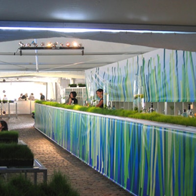 The 60-foot grass-covered bar displayed custom murals from StudioStampa.
