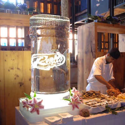 A branded ice sculpture by Iceculture for Renee's Gourmet Foods anniversary party at the Boilerhouse was accented with flowers from Church Street Flowers.