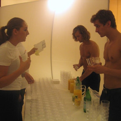 Shirtless waiters served champagne and Perrier.