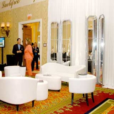 Grand Events of Florida created a white lounge area complete with plush leather seating and mirrored screen dividers.