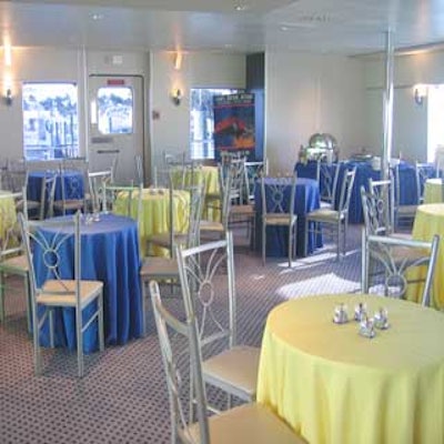 At an event for Walt Disney Parks & Resorts aboard the Biscayne lady, the yacht's interior was decorated with blue and yellow tables topped with mini Mickey Mouse snow globes.