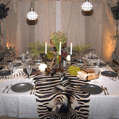 Doug Hall paid homage to Banana Republic's expedition-wear roots--and a new collection debuting in the fall--with a safari table that featured an authentic zebra skin draped over the top of the table dotted with pewter-colored chargers. Gauze fabric draped over a large bamboo frame surrounded the table.