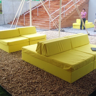 Pairs of yellow fabric-covered cushions were set up in five areas around the dinner tables.