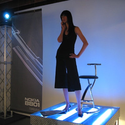 Models from Ford Models posed with the new phones atop glowing blue risers.