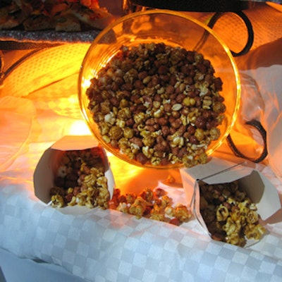 ByPeterandPauls.com's Table Talk served homemade Cracker Jack-style snack mix at the buffet stations, lit in gold by Westbury National Show Systems.